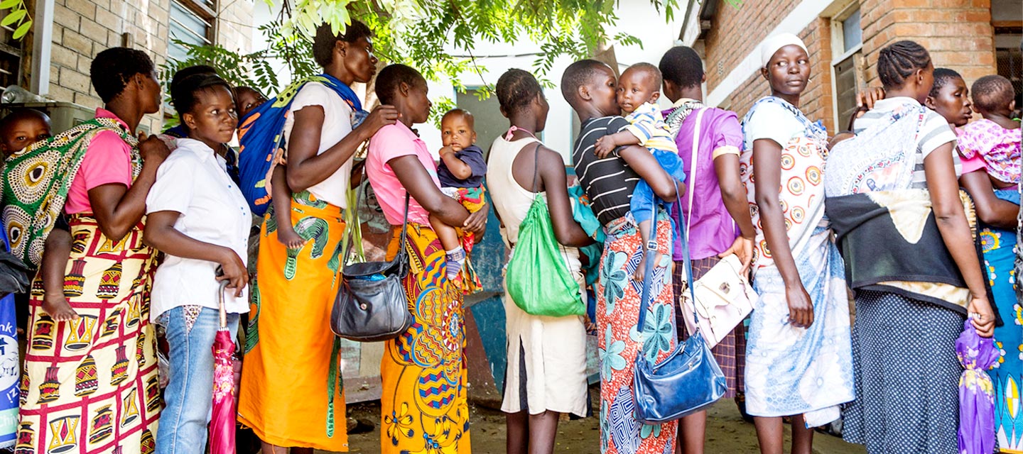 Line of people waiting to enter a health center in Malawi